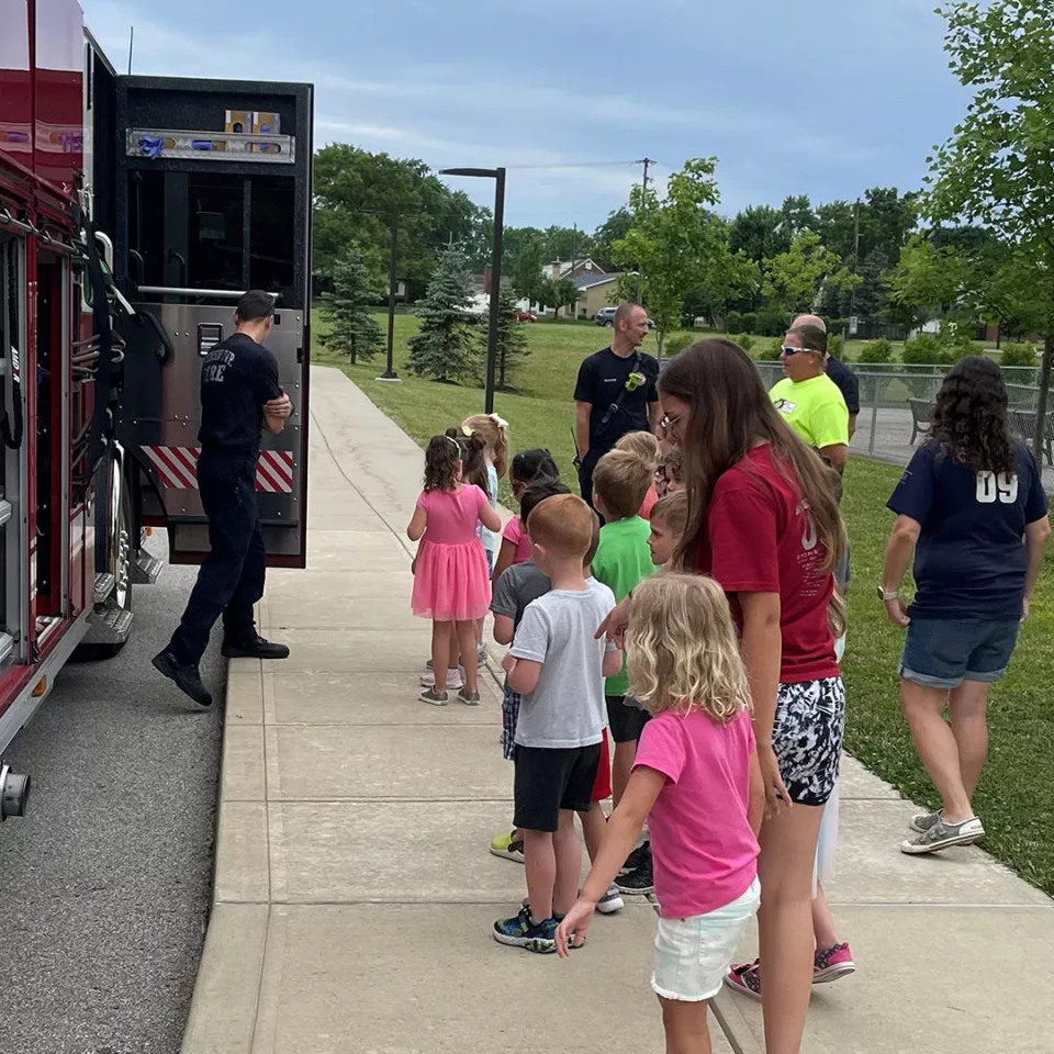 Group of kids standing by a Fire Truck